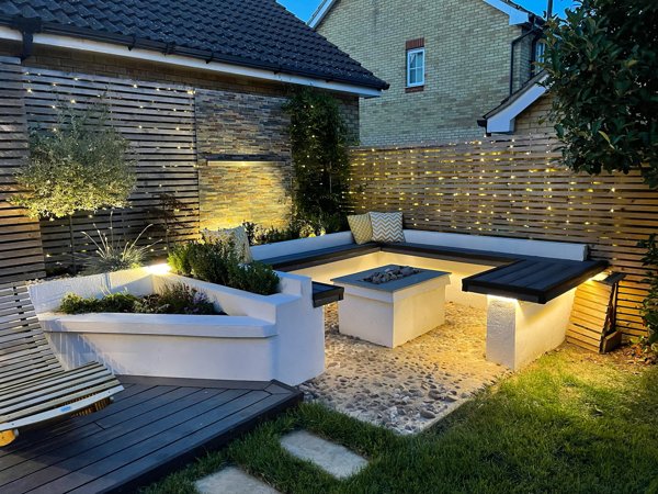 Contemporary garden seating area with professional lighting installation